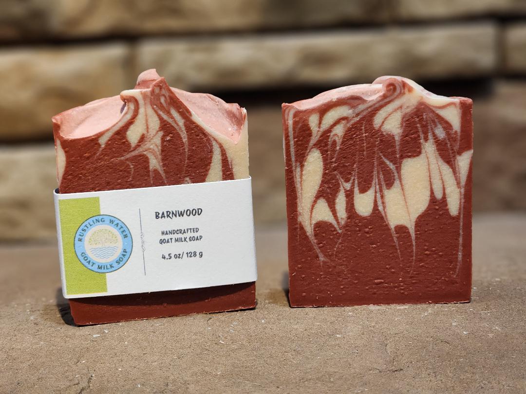 Two bars of soap with a visible label on a stone surface