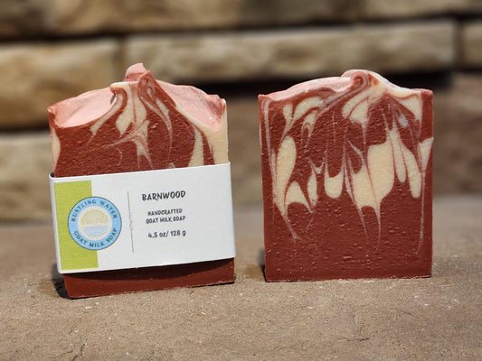 Two bars of soap with a visible label on a stone surface