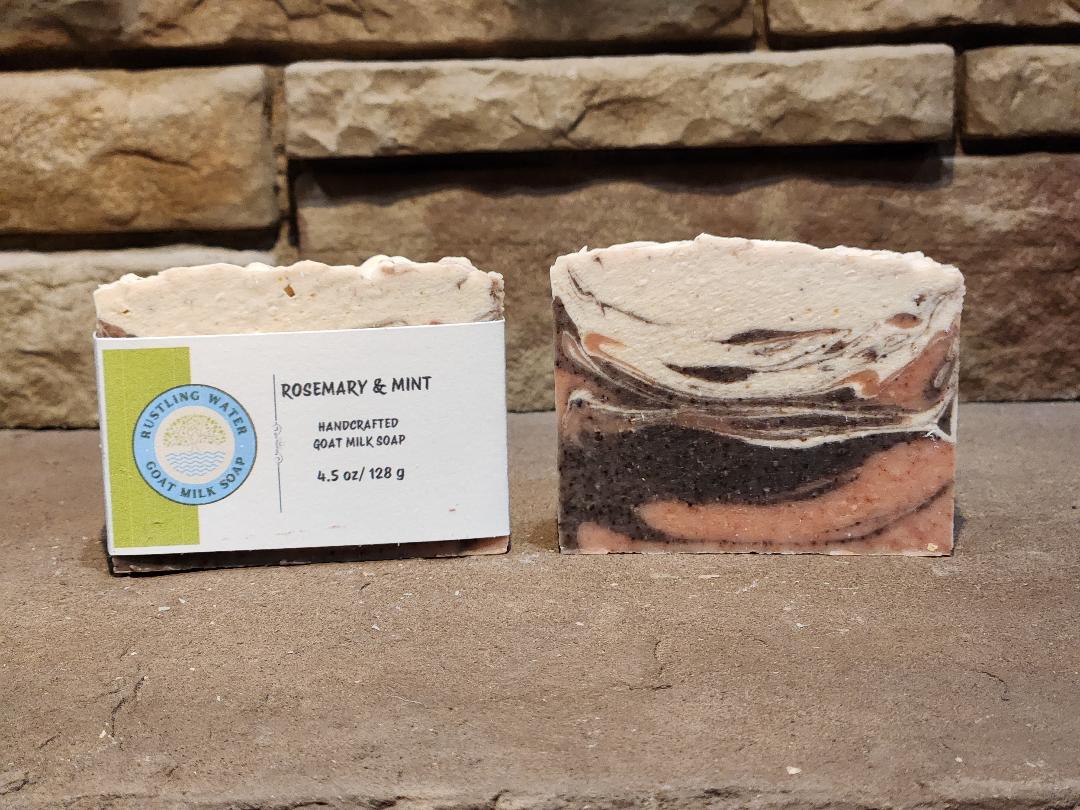 Two bars of soap with a label in front of a stone wall