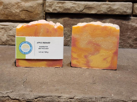Two bars of soap with a visible label on a stone surface